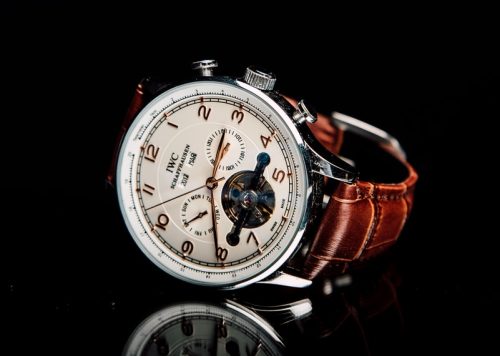 round silver-colored chronograph watch with brown leather strap
