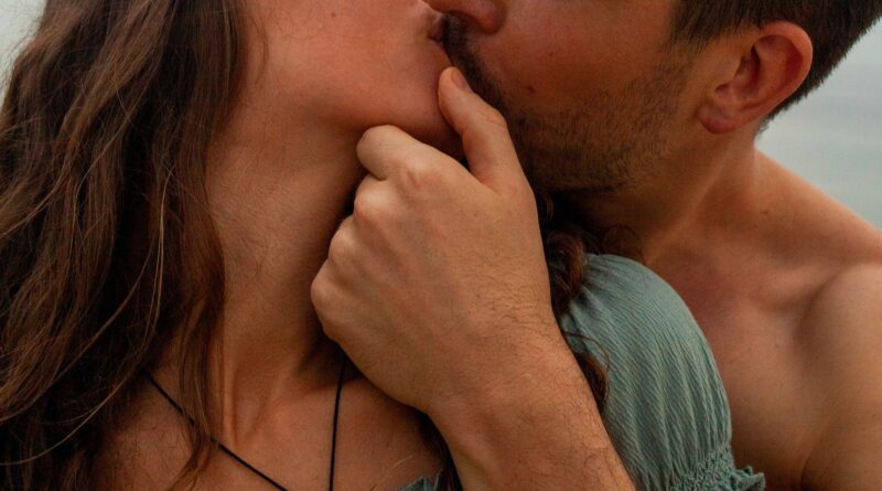 man kissing womans cheek