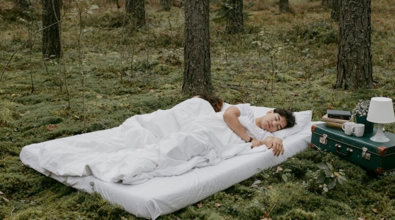 A Couple Sleeping Outdoors over a Mattress
